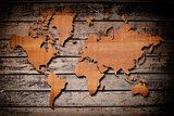 World map carving on wood plank. 