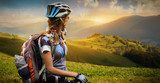 Young woman with bicycle standing in the mountains 